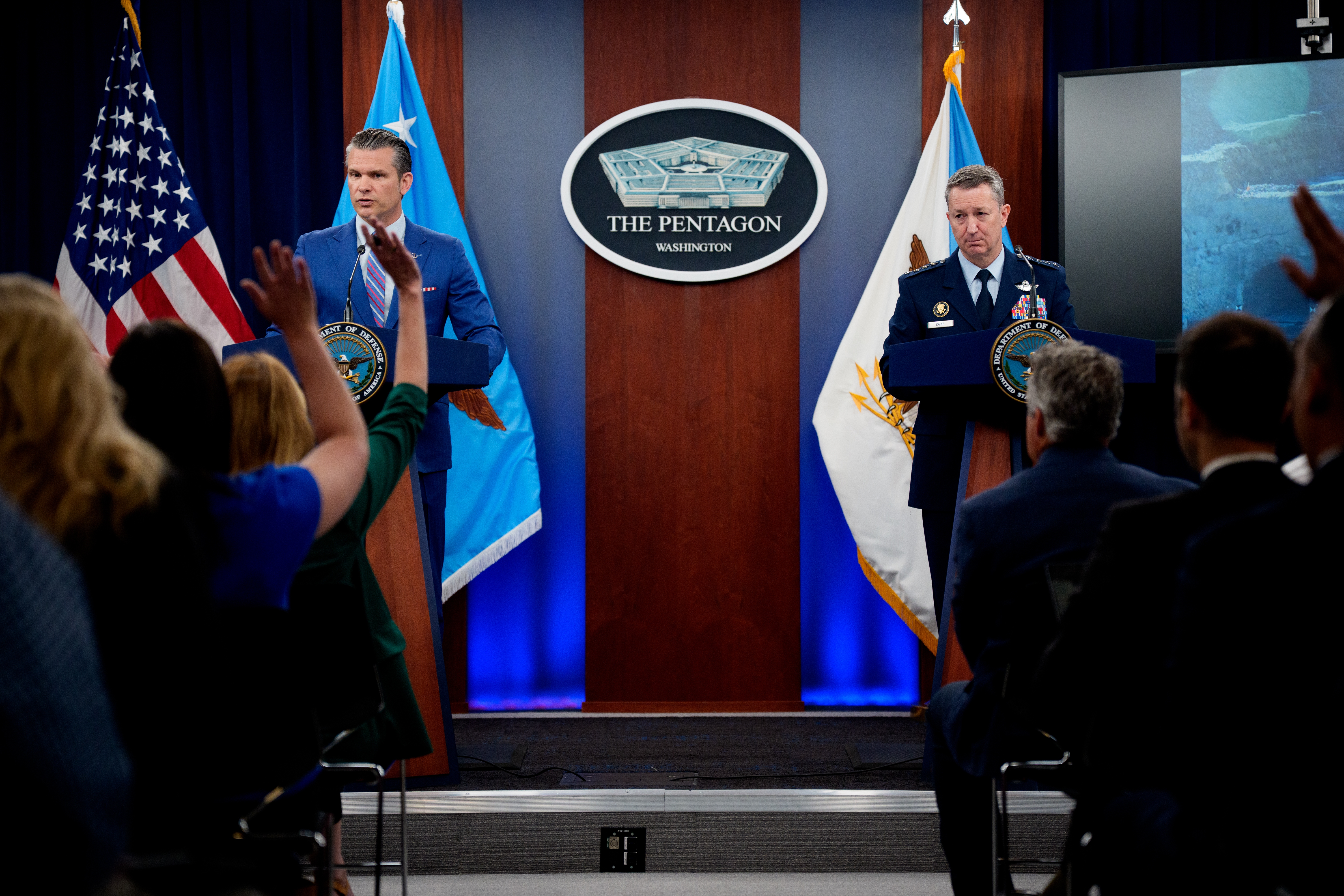 U.S. Defense Secretary Pete Hegseth (L), accompanied by Chairman of the Joint Chiefs of Staff Air Force Gen. Dan Caine (R), speaks during a news conference at the Pentagon in June in Arlington, Va.